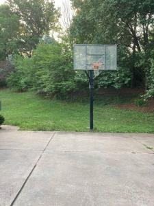 a basketball hoop with a basket in a park at AirBnB Florissant, fire pit - pool open! in Florissant