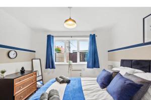 a bedroom with a bed with blue curtains and a dresser at Beautiful Lincoln Abode - Sleeps 6 - Parking in Lincoln