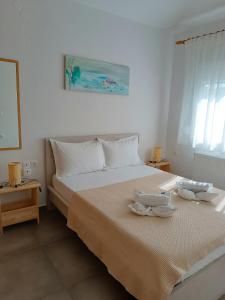 una camera da letto con un grande letto con due piatti sopra di Niki Apartments Beach Loft a Platamonas