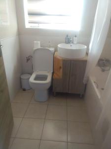 a bathroom with a toilet and a sink at Recoupe in East London