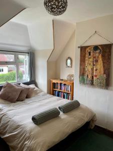 a bedroom with a bed with two pillows on it at Pilgrims Rest with Annexe in Cheddar