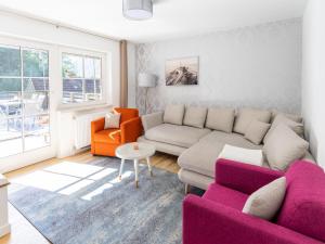 a living room with a couch and two chairs at Holiday apartment in Feld am See in Carinthia in Feld am See