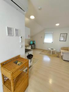 a living room with a table and a couch at A1 - Airport Belgrade Apartment in Belgrade