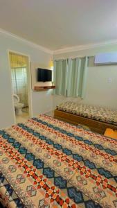 Habitación de hotel con 2 camas y TV en Flat Di Roma Resort Internacional, en Caldas Novas