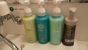 four bottles of detergent are lined up on a counter at Hotel Route-Inn Iwata Inter in Iwata