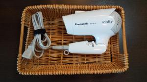 a wicker basket with a hair dryer and a hair brush at Hotel Route-Inn Iwata Inter in Iwata +39 photos