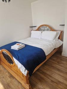 a bedroom with a large bed with a blue comforter at Beautiful 1-Bed Apartment in Cork in Cork