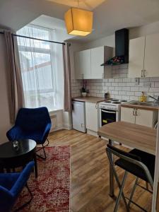 a kitchen with a table and chairs and a table and a dining room at Beautiful 1-Bed Apartment in Cork in Cork
