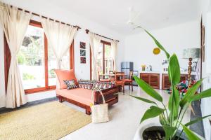 a living room with a couch and a table at Babu Villas in Jambiani