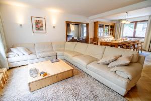 a living room with a couch and a table at Ferienhaus Mühlenberg in Monschau +26 photos