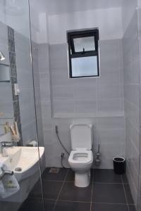 a bathroom with a toilet and a sink at Hotel Lourdes, Siaya in Siaya