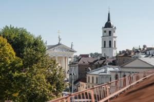 a view of a city with a clock tower at CATHEDRAL Old Town Suites in Vilnius