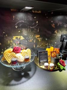 a display of waffles and other food on a table at LES SECRETS ROOMS - BONNEVILLE - LOVE ROOM 130m2 - SPA PRIVATIF in Bonneville
