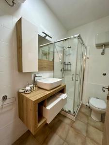 a bathroom with a sink and a shower and a toilet at F&F Appartments in Iglesias