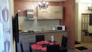 a small kitchen with a table and a counter top at Apartment Decebal in Mamaia