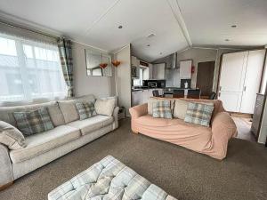 a living room with two couches and a kitchen at Stunning Dog Friendly Caravan At Manor Park, Hunstanton In Norfolk Ref 23188k in Hunstanton