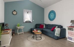 ein Wohnzimmer mit einem blauen Sofa und einem Tisch in der Unterkunft Nice Home In Barban With Outdoor Swimming Pool in Barban