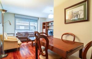 a living room with a table and chairs and a couch at 2 Bedroom Amazing Apartment In Granada in Granada