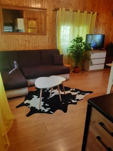 a living room with a couch and a table at Domek u Prezesa in Kłótno +19 photos