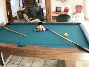 a pool table with two cue balls on it at Grande demeure familiale in Les Déserts