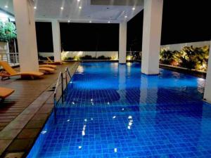 a swimming pool with blue tiles in a hotel at The Verdin at Maple Grove in Cavite