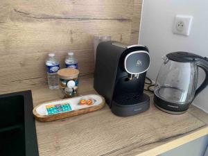 a counter with a blender and a toaster on it at La Suite Saphir – spa privatif in Nancy