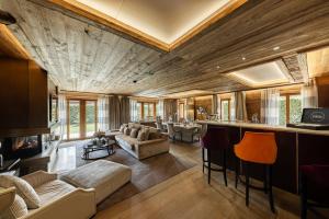 a living room with a couch and a bar at Ultima Gstaad Residences in Gstaad