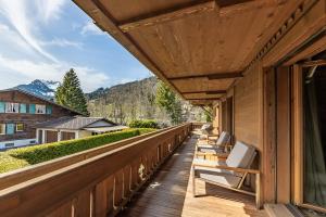 a balcony with chairs and a view of the mountains at Ultima Gstaad Residences in Gstaad