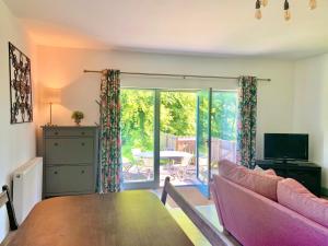 a living room with a couch and a table at The Stables in Meikle Wartle