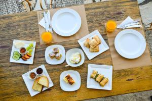 a table topped with plates of food and orange juice at Archontiko Zafeiropoulou in Kalavrita