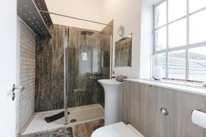 a bathroom with a shower and a toilet at Loftnine9 in Liverpool