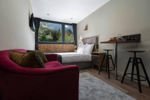 ein Schlafzimmer mit einem Bett, einem Sofa und einem Fenster in der Unterkunft Modern apartment with the best Mont Blanc view! in Chamonix-Mont-Blanc