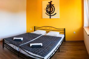 a bedroom with a bed with two pillows on it at LAAS ART GALLERY in Stari Trg pri Ložu