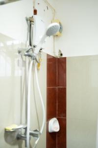 a shower in a bathroom with a shower head at The Greens Home & Garden - ENTIRE 3RD FLOOR in Baguio