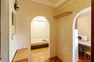 a room with a bed and a hallway with an archway at Kvartirkoff na Polku Azov 32b in Kyiv