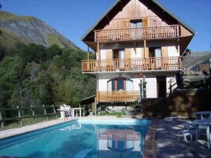 a house with a swimming pool in front of a house at Appartement 10 in Saint-Sorlin-dʼArves