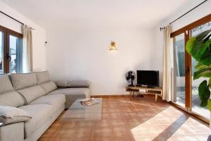 a living room with a couch and a tv at Villa Charlotte in La Oliva