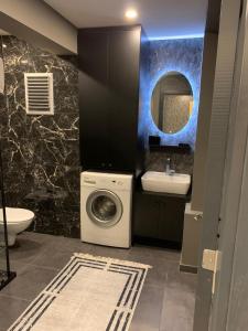 a bathroom with a washing machine and a sink at wonderful and great Flat in Perfect Location Nişantaşı in Istanbul