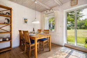 a dining room with a table and chairs and a window at Wohnung 1 Terrassenwohnung in Stockelsdorf