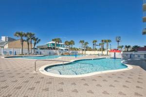 a swimming pool at a resort with palm trees at Beachfront Condo #1413 Majestic Beach Resort in Panama City Beach