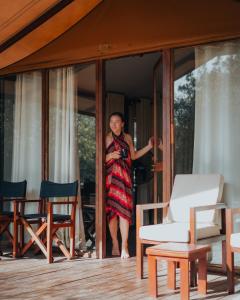 a woman standing in the doorway of a house at Wild Trails Yala by Suri in Yala