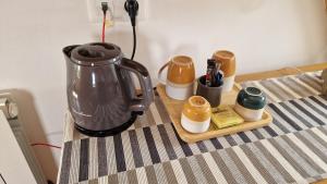 a kitchen counter with a coffee maker on a table at Les Tilleuls in Neung-sur-Beuvron