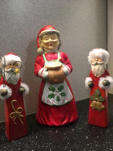 three figurines of santa claus on a table at Aurora Center 3 in Rovaniemi