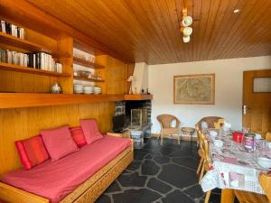 a living room with a couch and a dining room table at Appartement proche des pistes avec terrasse sud - FR-1-411-687 in Les Allues
