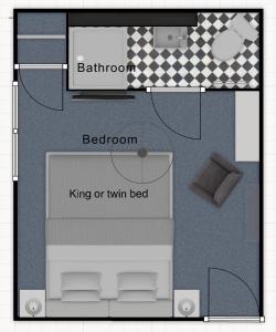 a floor plan of a bedroom with a bed and a laptop at St John's Guest House in Weymouth