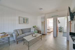 a living room with a couch and a table at Cozy Hampton Vacation Rental, Walk to Beach! in Hampton