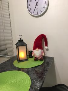 a santa claus figurine on a table next to a clock at Aurora Center 3 in Rovaniemi