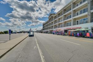 a car driving down a street next to a building at Charming Hampton Home with Porch, Walk to Beach! in Hampton