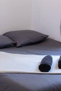 a stuffed animal is sitting on a bed at Le Cocon Urbain en Hyper Centre in La Rochelle +6 photos