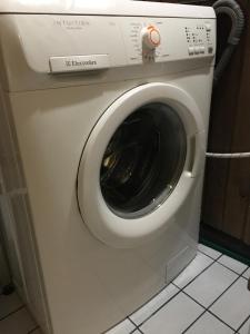 a white washing machine with its door open at Aurora Center 3 in Rovaniemi